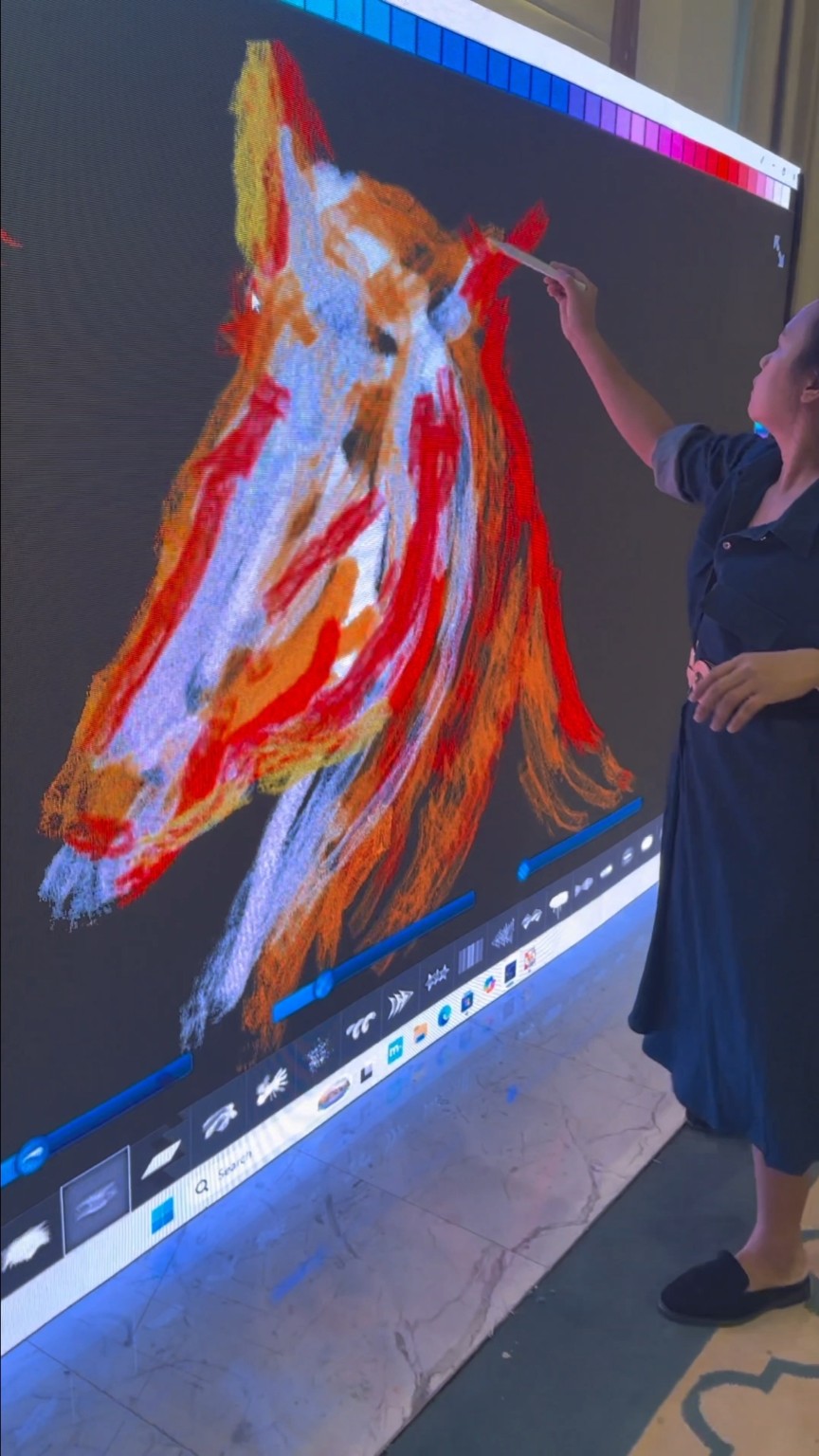 Guest painting on a giant interactive art wall